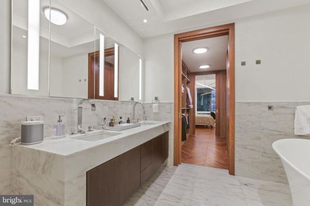 Bathroom, Dual Sink Vanities, Free Standing Baths, Interior, Marble, Marble Walls, Recessed Lighting, Wood Texture Flooring