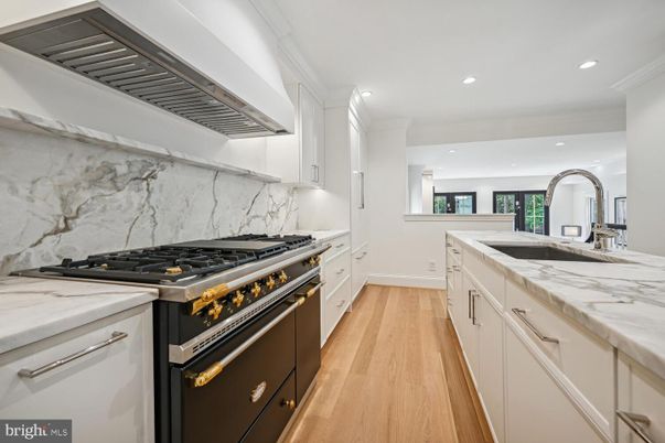 Interior, Kitchen, Marble Walls, Recessed Lighting, Stainless Steel Appliances, Wood Texture Flooring
