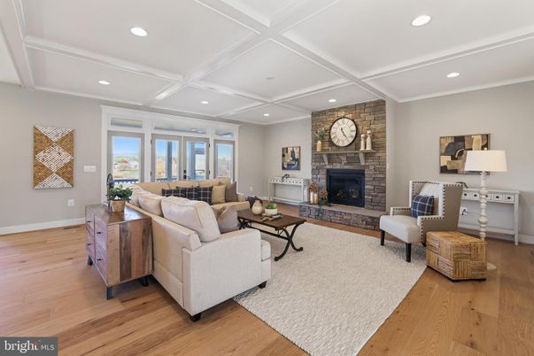 Fireplace, Interior, Living room, Recessed Lighting, Stone Walls, Wood Texture Flooring