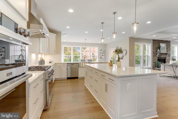 Fireplace, Interior, Kitchen, Pendant Lights, Recessed Lighting, Stainless Steel Appliances, Stone Walls, Wood Texture Flooring
