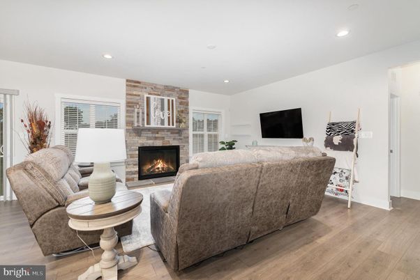 Fireplace, Interior, Living room, Recessed Lighting, Stone Walls, Wood Texture Flooring