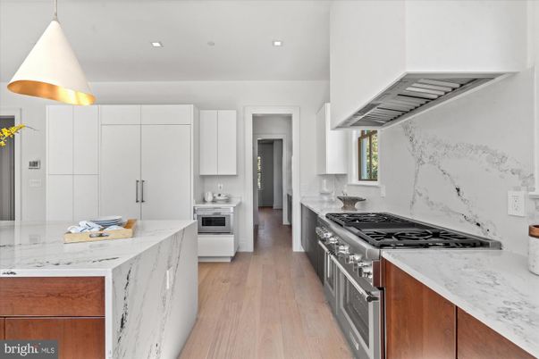 Interior, Kitchen, Marble Walls, Recessed Lighting, Stainless Steel Appliances, Wood Texture Flooring