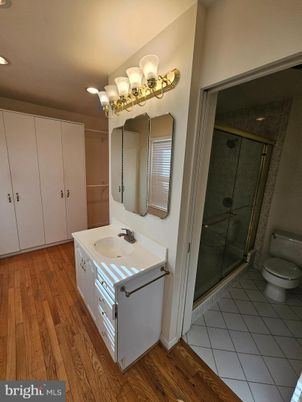 Bathroom, Dual Sink Vanities, Glass Shower, Interior, Recessed Lighting, Wood Texture Flooring