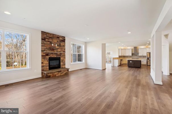 Empty room, Fireplace, Interior, Kitchen, Recessed Lighting, Stone Walls, Wood Texture Flooring