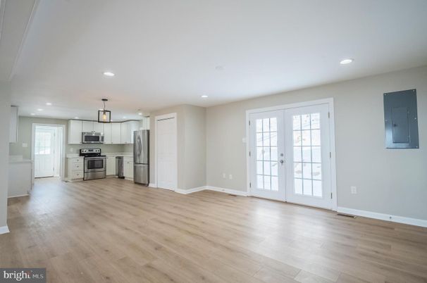 Empty room, Interior, Kitchen, Pendant Lights, Recessed Lighting, Stainless Steel Appliances, Wood Texture Flooring