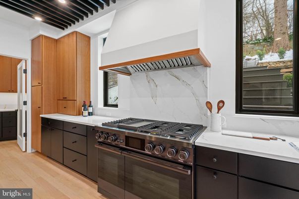 Interior, Kitchen, Marble Walls, Recessed Lighting, Stainless Steel Appliances, Wood Texture Flooring