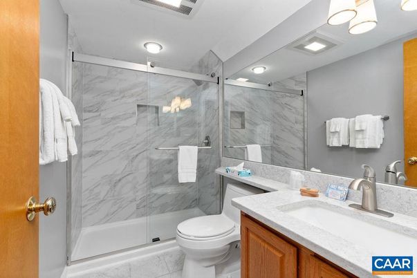 Bathroom, Dual Sink Vanities, Glass Shower, Interior, Marble Walls, Recessed Lighting