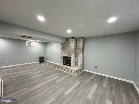 Empty room, Fireplace, Interior, Recessed Lighting, Stone Walls, Wood Texture Flooring