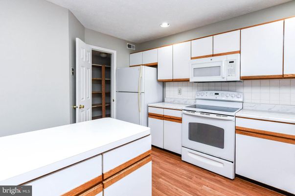 Interior, Kitchen, Recessed Lighting, Tile Countertops, Wood Texture Flooring