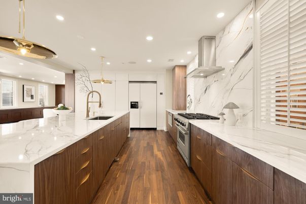 Interior, Kitchen, Marble Walls, Pendant Lights, Recessed Lighting, Stainless Steel Appliances, Wood Texture Flooring
