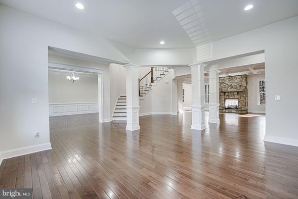 Chandelier, Empty room, Fireplace, Interior, Recessed Lighting, Stone Walls, Wood Texture Flooring