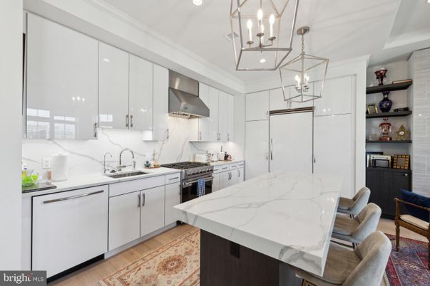 Interior, Kitchen, Marble Walls, Pendant Lights, Recessed Lighting, Stainless Steel Appliances, Wood Texture Flooring