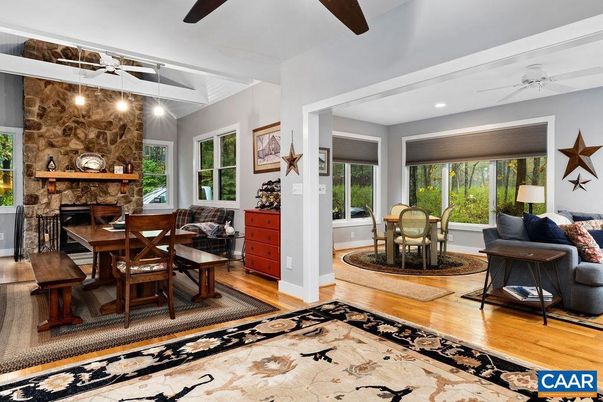 Dining room, Fireplace, Interior, Living room, Recessed Lighting, Stone Walls, Wood Texture Flooring