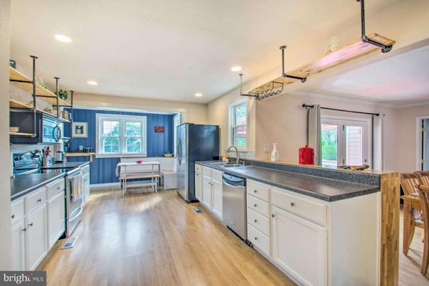 Dining room, Interior, Kitchen, Pendant Lights, Recessed Lighting, Stainless Steel Appliances, Wood Texture Flooring
