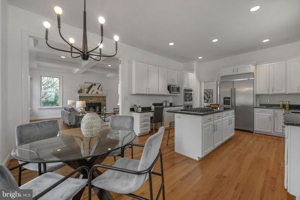 Chandelier, Dining room, Fireplace, Interior, Kitchen, Living room, Recessed Lighting, Stainless Steel Appliances, Wood Texture Flooring