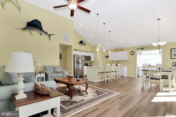 Chandelier, Dining room, Interior, Kitchen, Living room, Pendant Lights, Recessed Lighting, Stainless Steel Appliances, Wood Texture Flooring