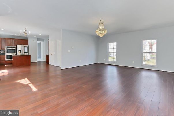 Chandelier, Empty room, Interior, Kitchen, Recessed Lighting, Stainless Steel Appliances, Wood Texture Flooring