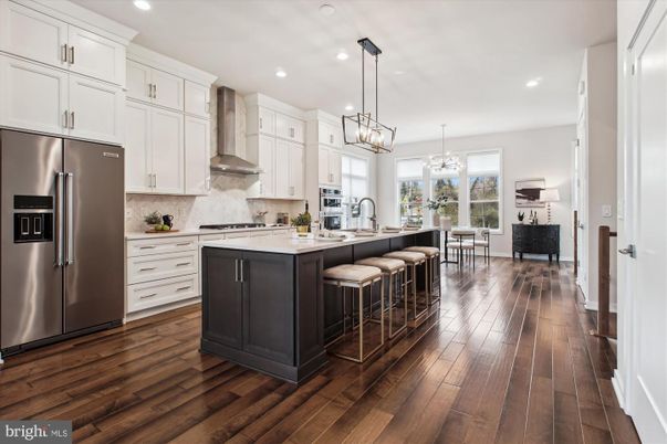 Chandelier, Dining room, Interior, Kitchen, Living room, Pendant Lights, Recessed Lighting, Stainless Steel Appliances, Wood Texture Flooring
