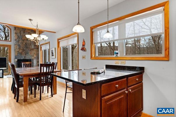 Chandelier, Dining room, Fireplace, Interior, Pendant Lights, Stone Walls, Wood Texture Flooring
