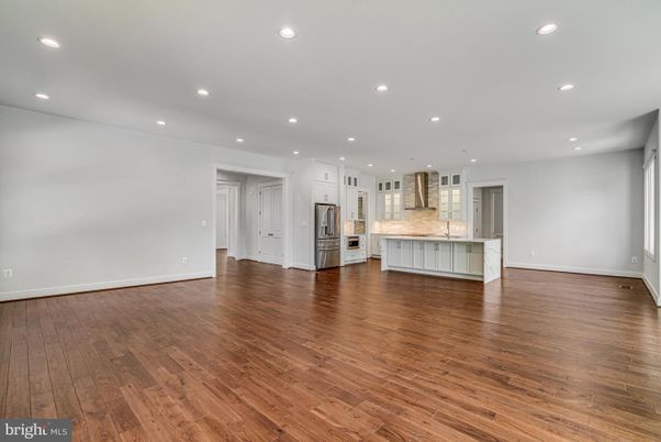 Empty room, Interior, Kitchen, Recessed Lighting, Stainless Steel Appliances, Wood Texture Flooring