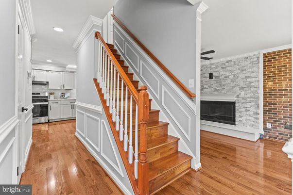 Fireplace, Interior, Kitchen, Recessed Lighting, Stainless Steel Appliances, Stone Walls, Wood Texture Flooring