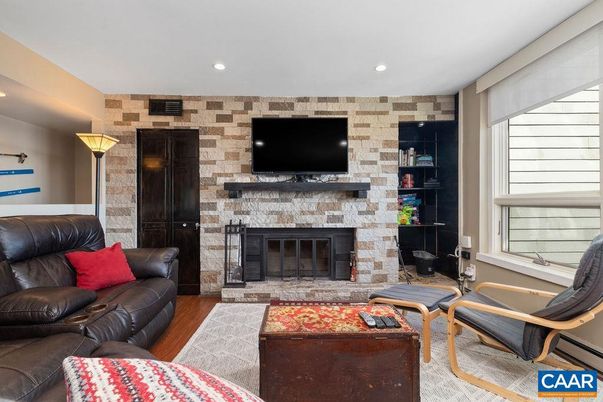 Fireplace, Interior, Living room, Recessed Lighting, Stone Walls, Wood Texture Flooring