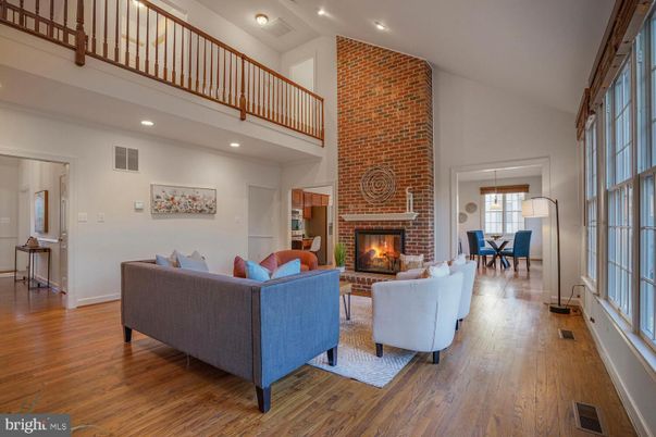 Dining room, Fireplace, Interior, Living room, Recessed Lighting, Stone Walls, Wood Texture Flooring