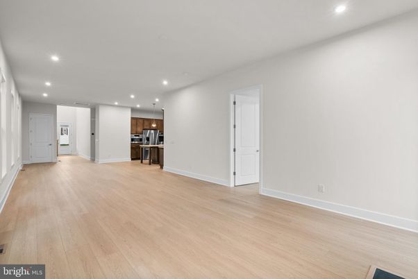 Empty room, Interior, Kitchen, Recessed Lighting, Stainless Steel Appliances, Wood Texture Flooring