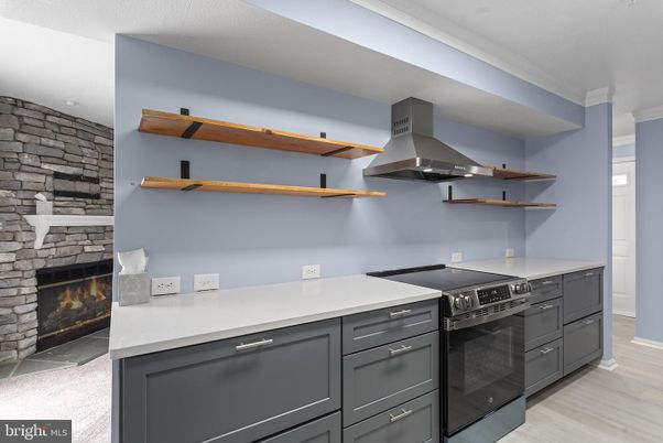 Fireplace, Interior, Kitchen, Stainless Steel Appliances, Stone Walls, Wood Texture Flooring