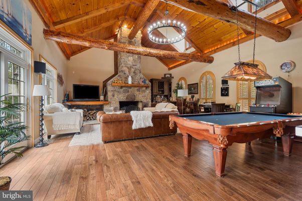 Billiard Table, Fireplace, Game Room, Interior, Living room, Pendant Lights, Stone Walls, Wooden Beams, Wooden Ceilings, Wood Texture Flooring