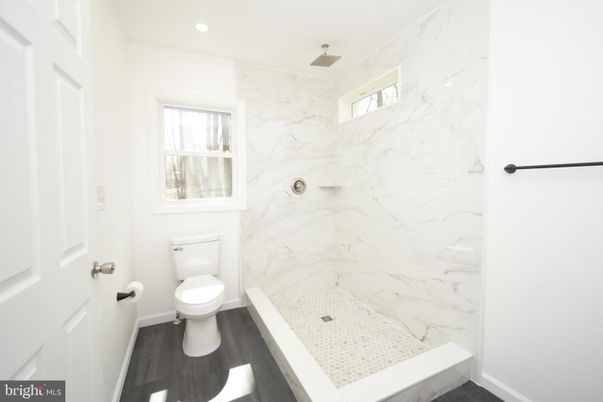 Bathroom, Glass Shower, Interior, Marble Walls, Recessed Lighting, Wood Texture Flooring