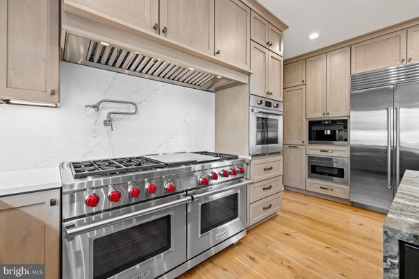 Interior, Kitchen, Marble Walls, Recessed Lighting, Stainless Steel Appliances, Wood Texture Flooring