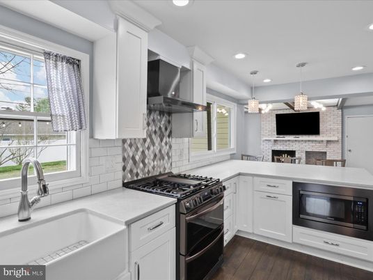 Fireplace, Interior, Kitchen, Pendant Lights, Recessed Lighting, Stainless Steel Appliances, Stone Walls, Wood Texture Flooring