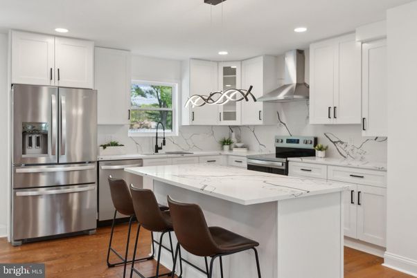 Interior, Kitchen, Marble Walls, Recessed Lighting, Stainless Steel Appliances, Wood Texture Flooring
