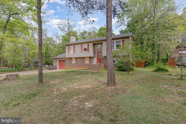 Attached, Backyard, Exterior, Facade, Brick Facade, Raised Ranch
