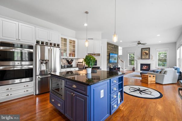 Fireplace, Interior, Kitchen, Living room, Pendant Lights, Recessed Lighting, Stainless Steel Appliances, Wood Texture Flooring
