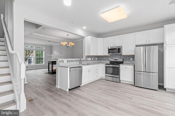 Chandelier, Fireplace, Interior, Kitchen, Recessed Lighting, Stainless Steel Appliances, Wood Texture Flooring