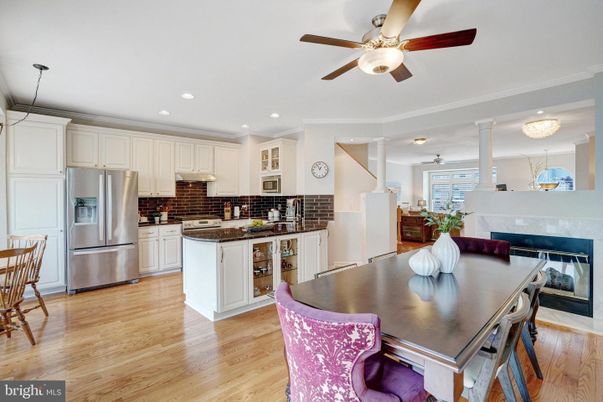Chandelier, Dining room, Fireplace, Interior, Kitchen, Pendant Lights, Recessed Lighting, Stainless Steel Appliances, Wood Texture Flooring