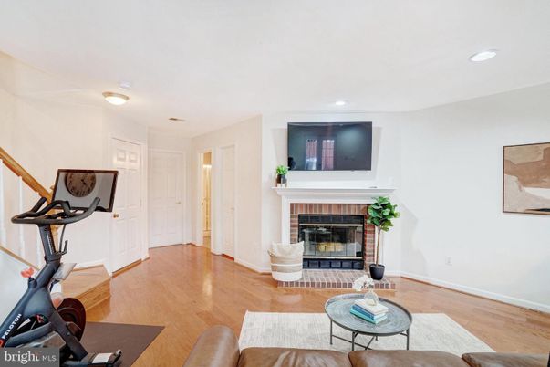 Fireplace, Fitness Equipment, Interior, Living room, Recessed Lighting, Wood Texture Flooring
