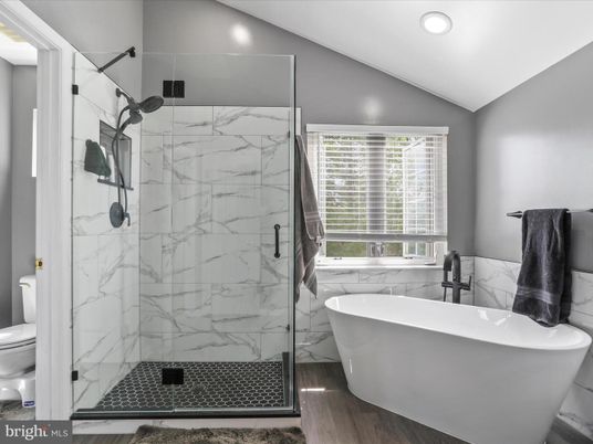 Bathroom, Free Standing Baths, Glass Shower, Interior, Marble Walls, Recessed Lighting, Wood Texture Flooring