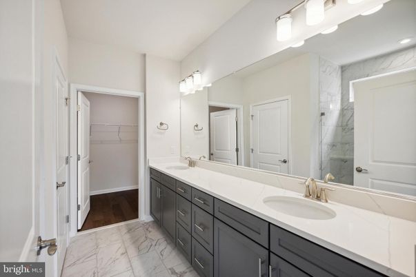 Bathroom, Dual Sink Vanities, Interior, Marble, Marble Walls, Recessed Lighting, Walk-in Closets, Wood Texture Flooring