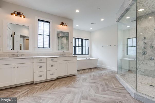 Bathroom, Dual Sink Vanities, Free Standing Baths, Glass Shower, Interior, Marble Walls, Recessed Lighting, Wood Texture Flooring
