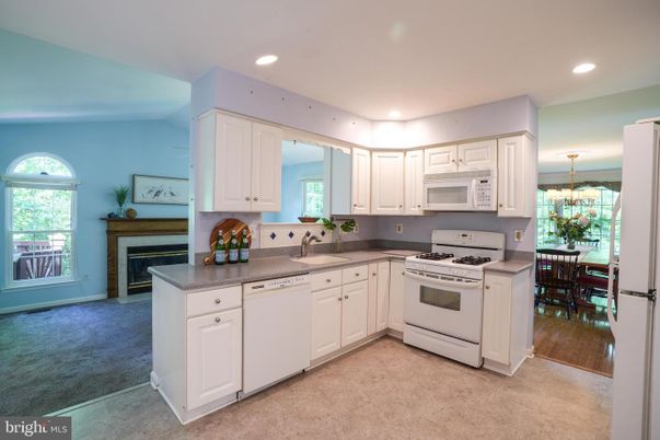 Chandelier, Dining room, Fireplace, Interior, Kitchen, Recessed Lighting, Stainless Steel Appliances, Wood Texture Flooring