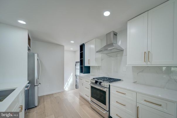 Interior, Kitchen, Marble Walls, Recessed Lighting, Stainless Steel Appliances, Wood Texture Flooring