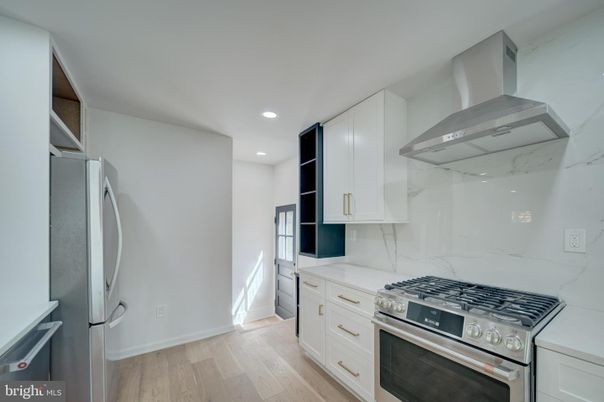 Interior, Kitchen, Marble Walls, Recessed Lighting, Stainless Steel Appliances, Wood Texture Flooring