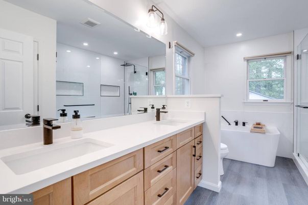 Bathroom, Dual Sink Vanities, Free Standing Baths, Glass Shower, Interior, Recessed Lighting, Wood Texture Flooring