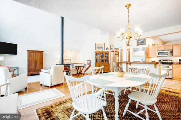 Chandelier, Dining room, Interior, Kitchen, Living room, Stainless Steel Appliances, Wood Texture Flooring