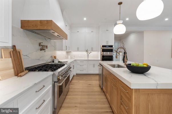 Interior, Kitchen, Marble Walls, Pendant Lights, Recessed Lighting, Stainless Steel Appliances, Wood Texture Flooring