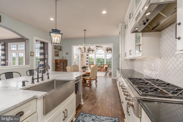 Chandelier, Dining room, Interior, Kitchen, Living room, Pendant Lights, Recessed Lighting, Stainless Steel Appliances, Wood Texture Flooring