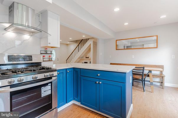 Interior, Kitchen, Marble Walls, Recessed Lighting, Stainless Steel Appliances, Wood Texture Flooring